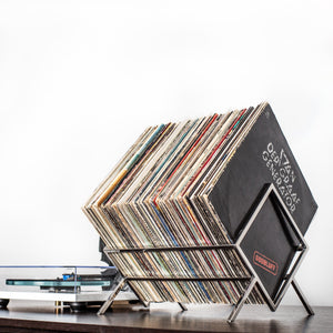 Stainless steel 1Romb vinyl record stand beside a turntable