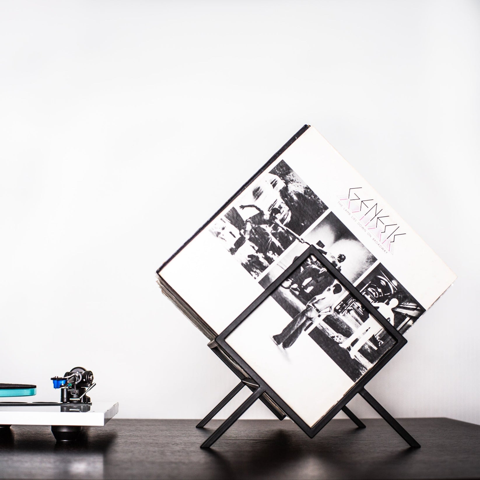 Black 1Romb record stand with an album cover visible