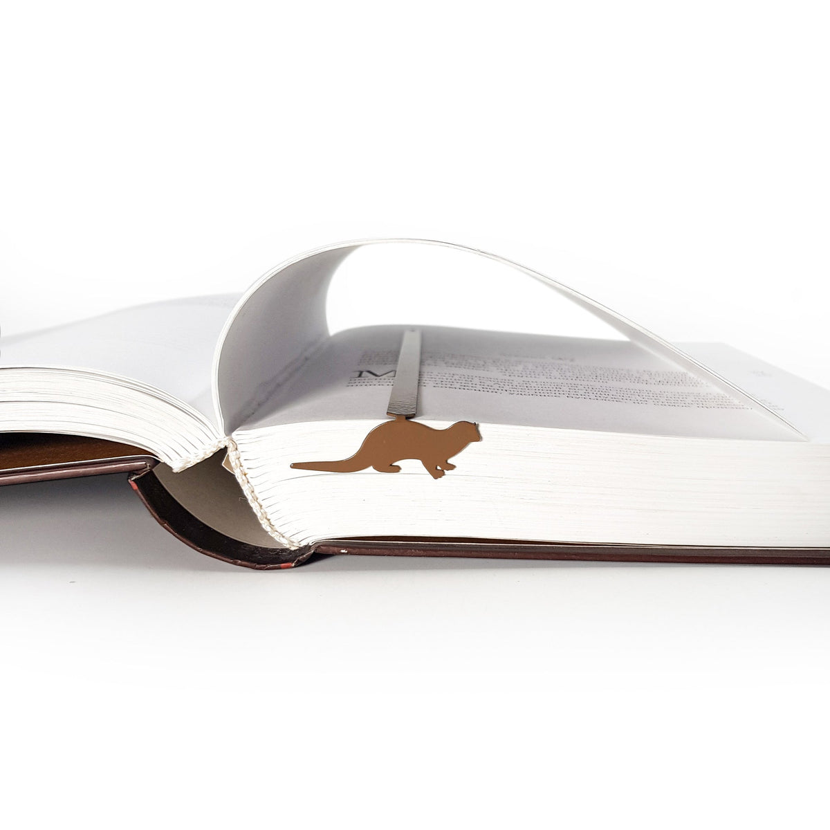 Otter bookmark marking a page in an open book