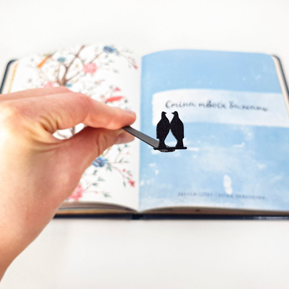 Pair of Pigeons metal bookmark on an illustrated page