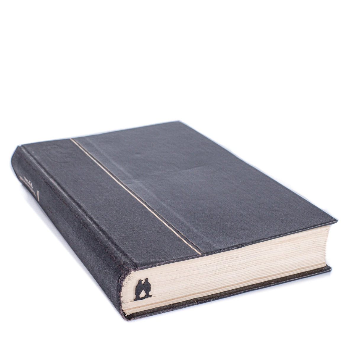 Pair of Pigeons metal bookmark clipped in a closed book, viewed from the side