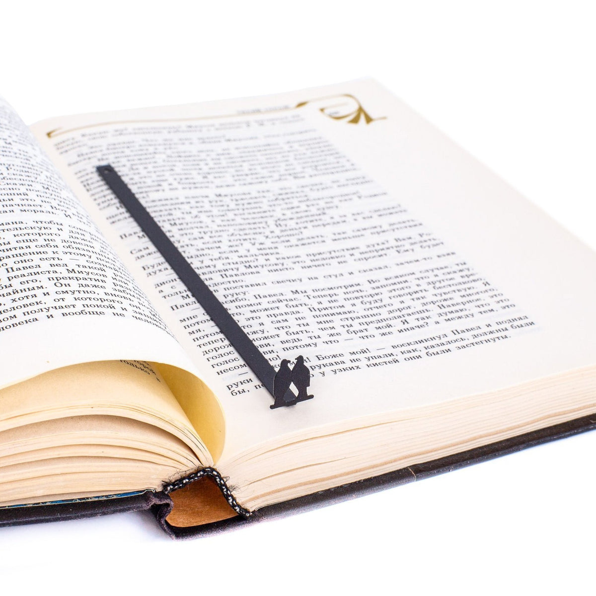 Pair of Pigeons metal bookmark marking a page in an open book