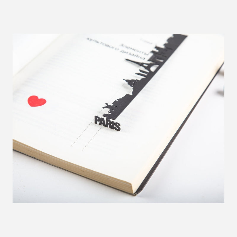 Paris metal bookmark resting on the pages of an open book