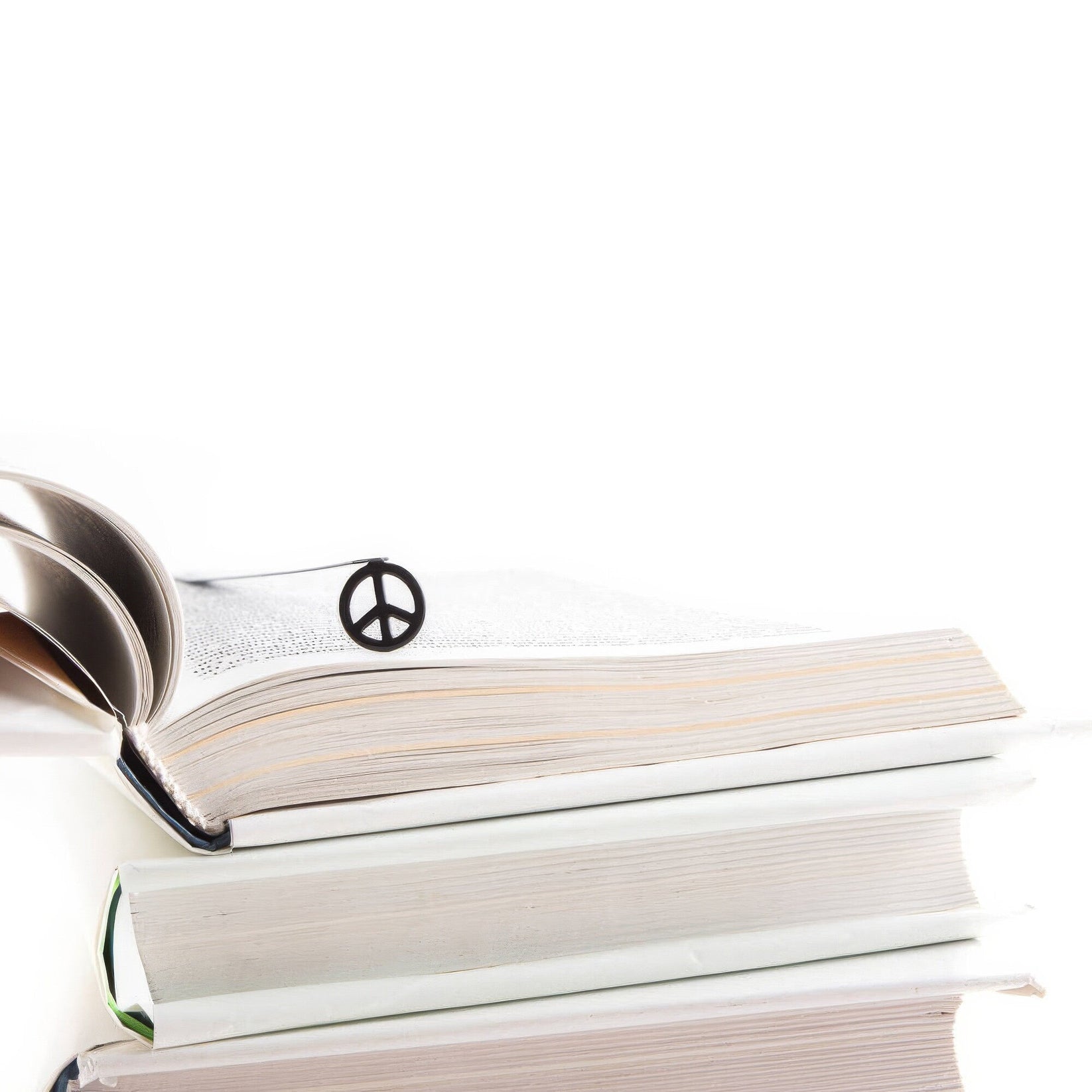 Peace metal bookmark shown with a stack of books