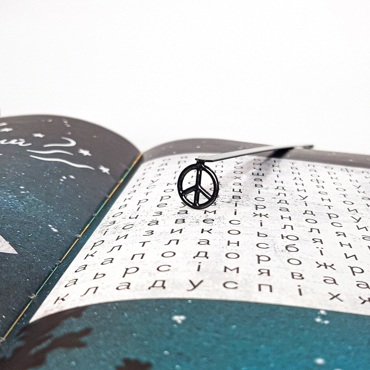 Peace metal bookmark against a coloured backdrop