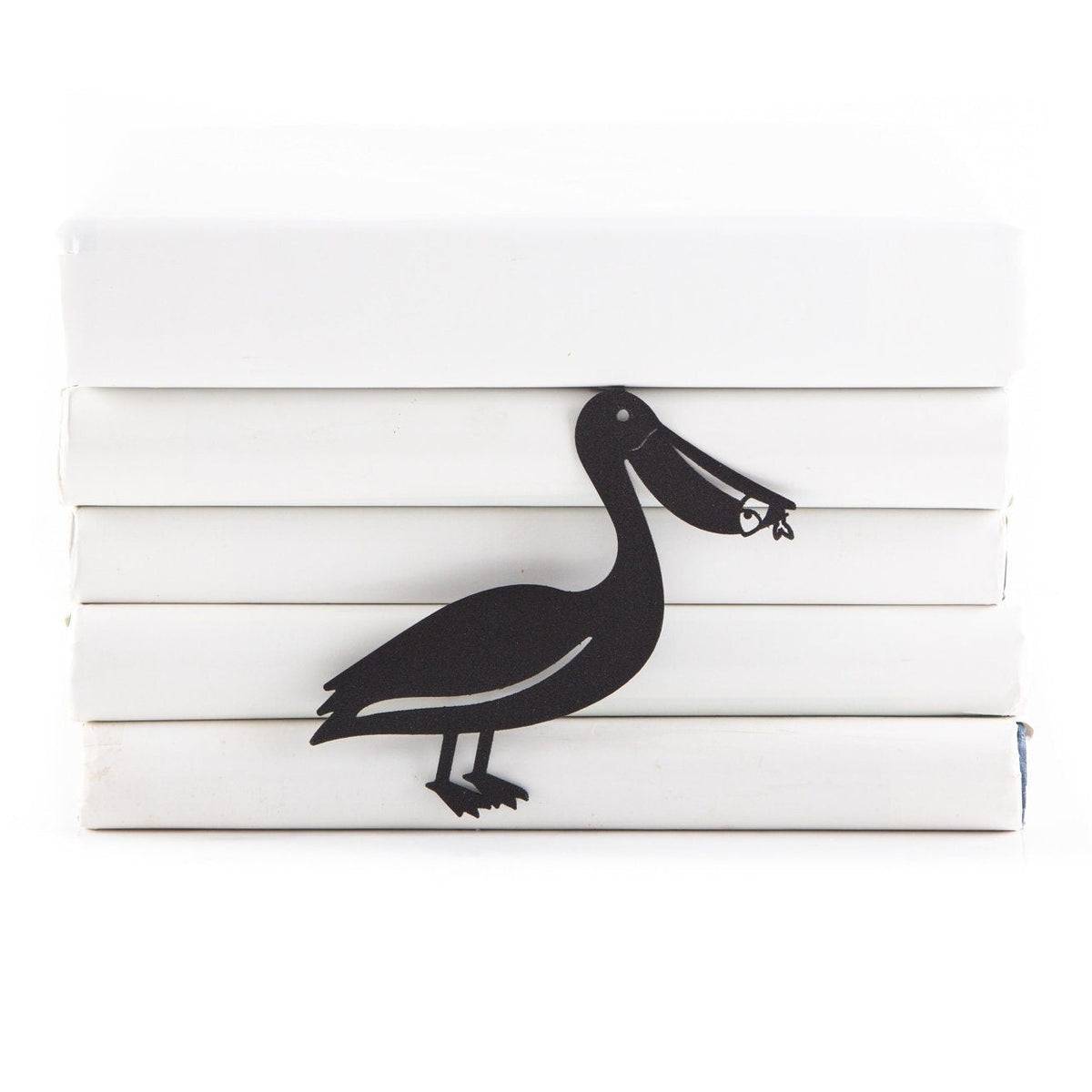 Pelican metal bookmark shown with a stack of books