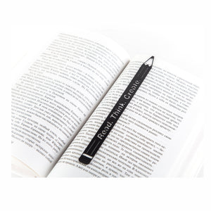Pencil Read, Think, Create metal bookmark resting on the pages of an open book