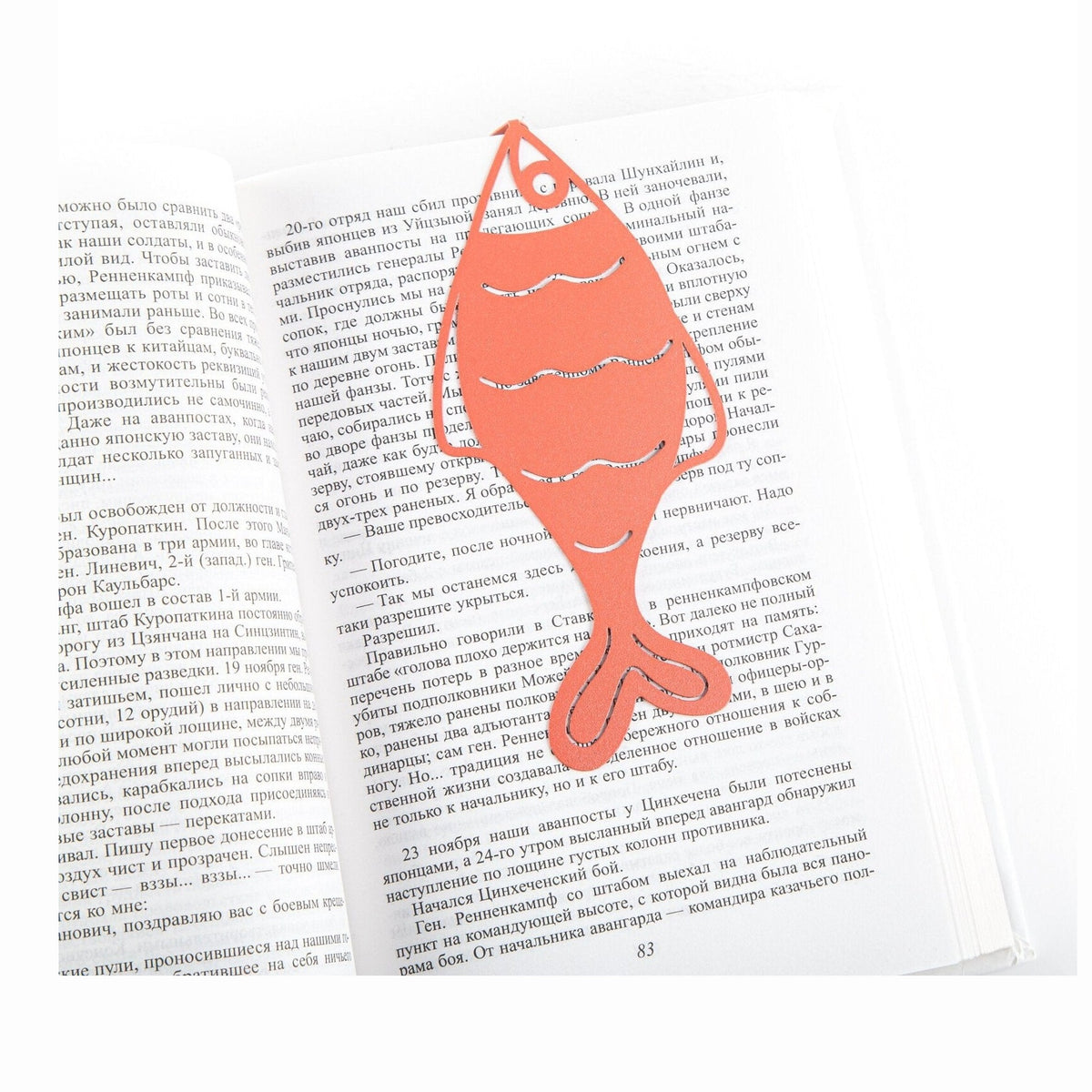 Perch metal bookmark in red resting on the pages of an open book