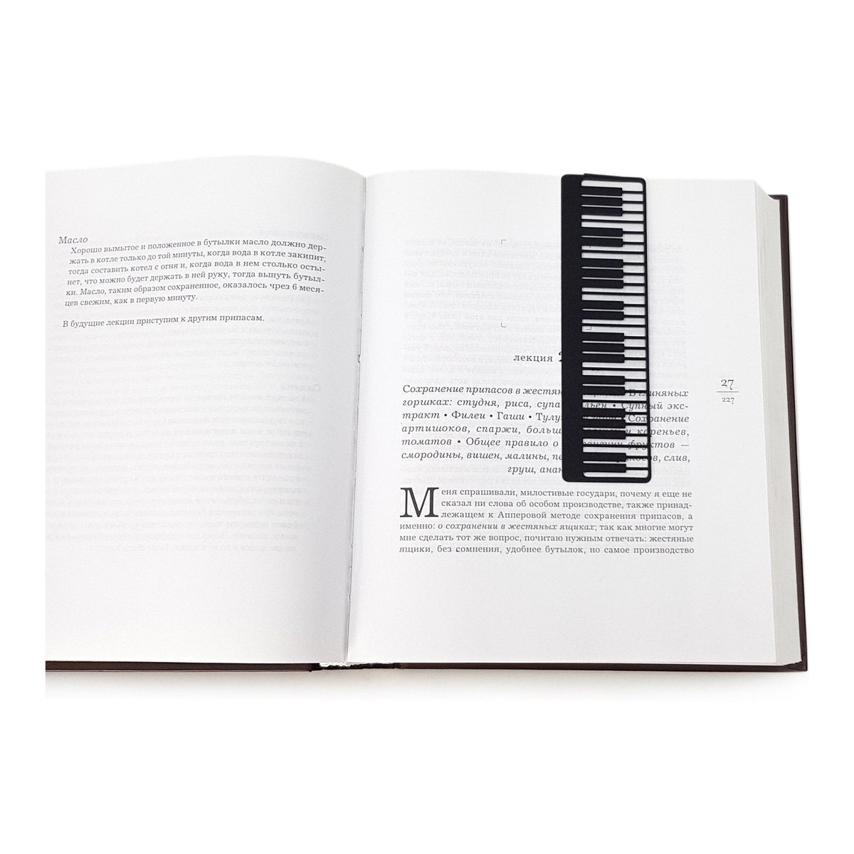 Piano Player metal bookmark resting on the pages of an open book