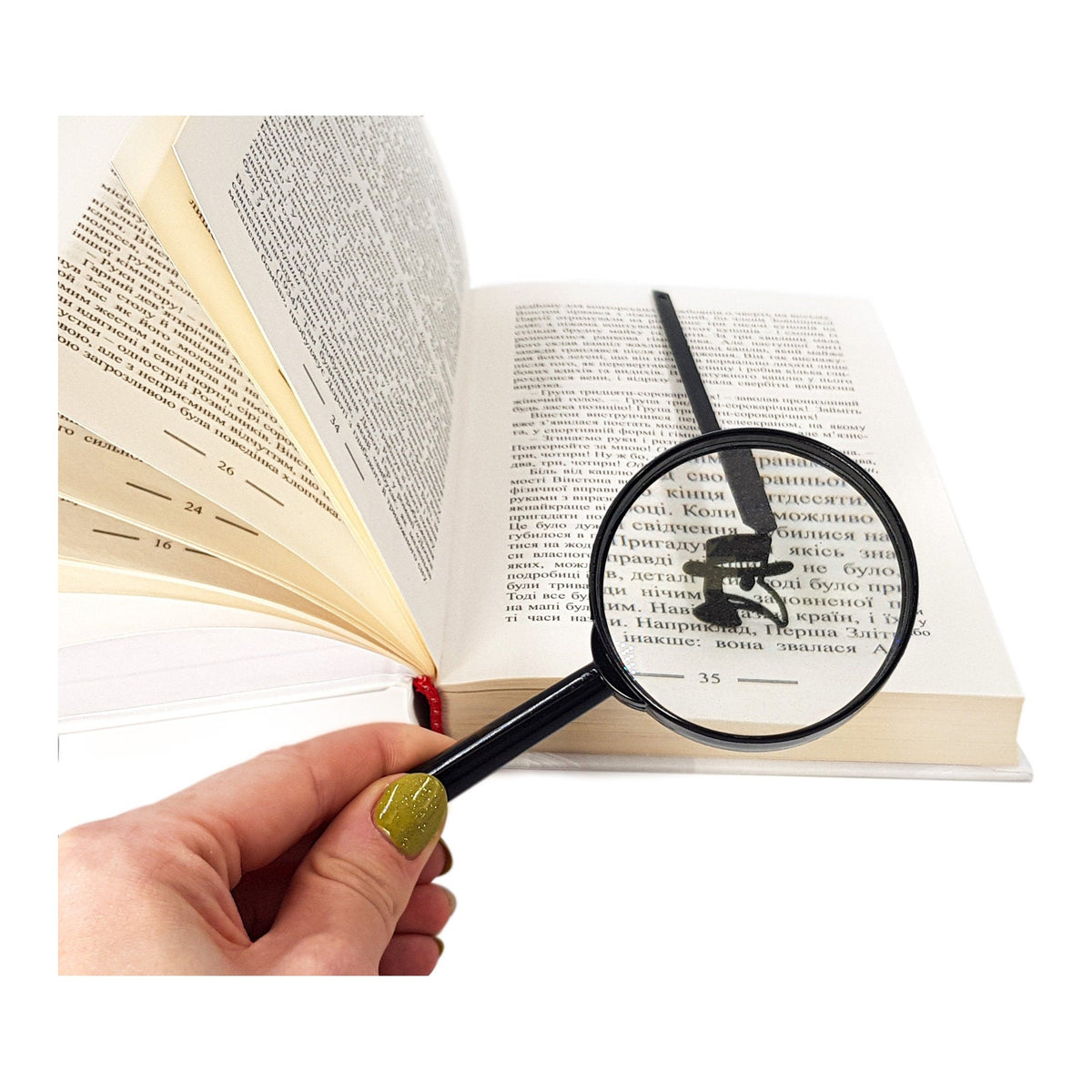 Plaque Doctor metal bookmark held in a hand above an open book