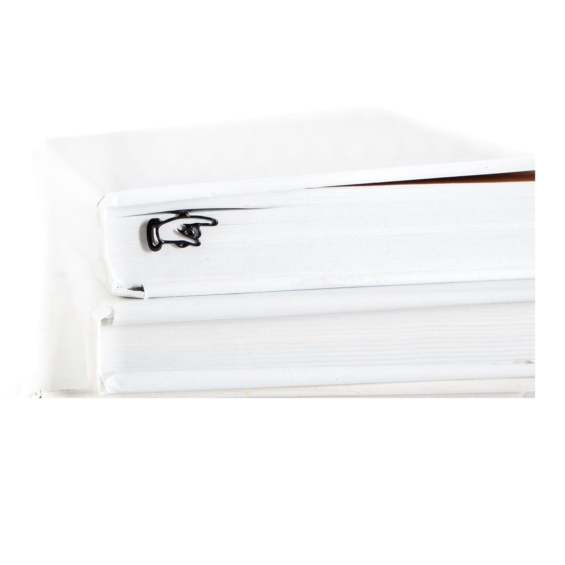 Pointing Finger metal bookmark shown with a stack of books