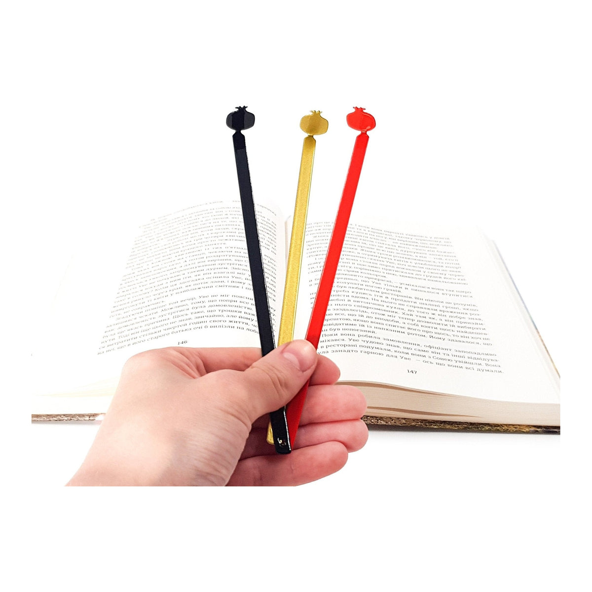 Pomegranate metal bookmark shown together with other bookmarks from the range