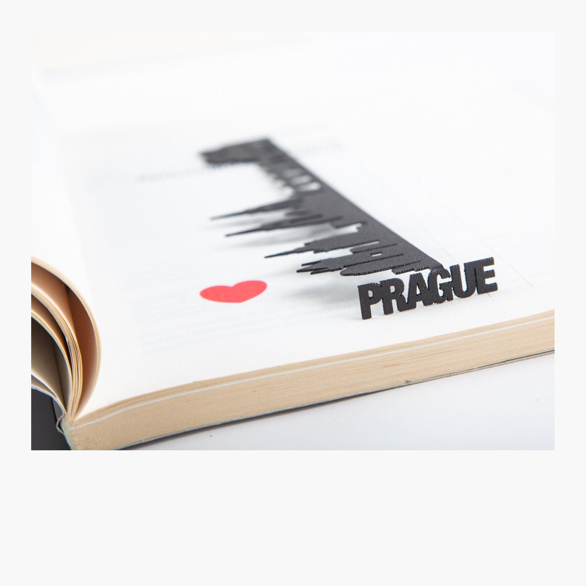 Prague Cityscape metal bookmark resting on the pages of an open book