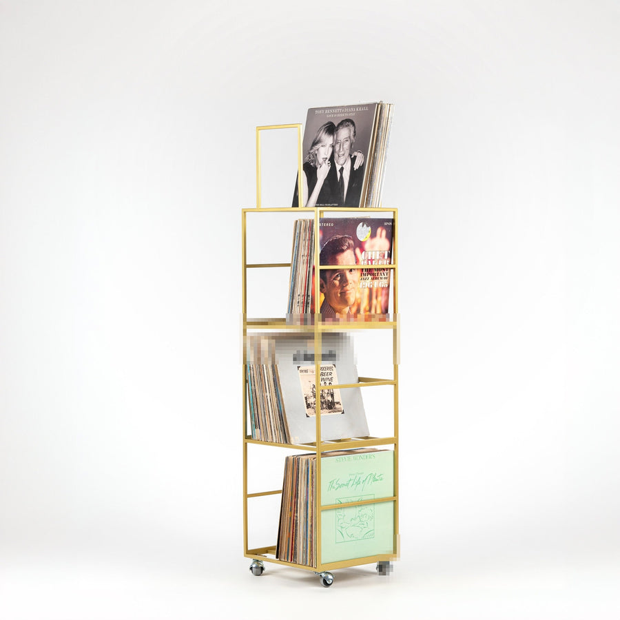 Four-tier metal vinyl record stand holding records on multiple shelves