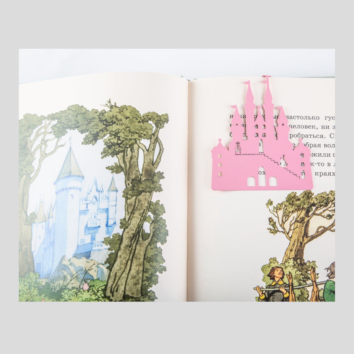Princess Castle in Pink metal bookmark in red marking a page in an illustrated book