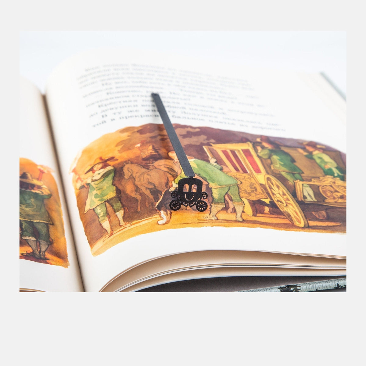Princess's Carriage metal bookmark marking a page in an illustrated book