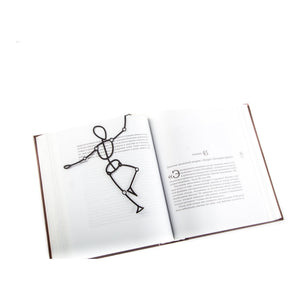 Reading Dummy Model metal bookmark resting on the pages of an open book