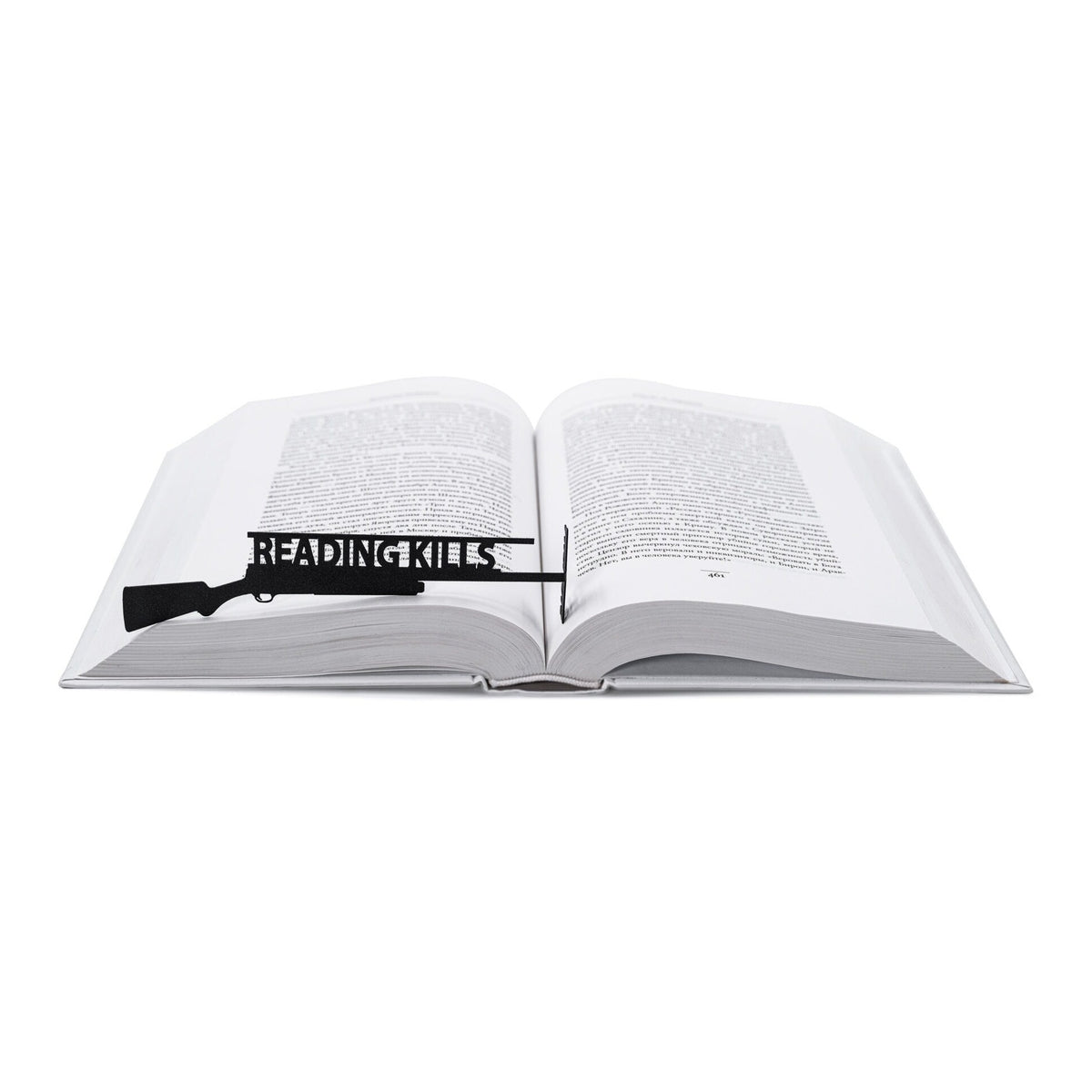 Reading Kills Stupidity metal bookmark resting on the pages of an open book