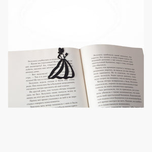 Reading Princess metal bookmark resting on the pages of an open book