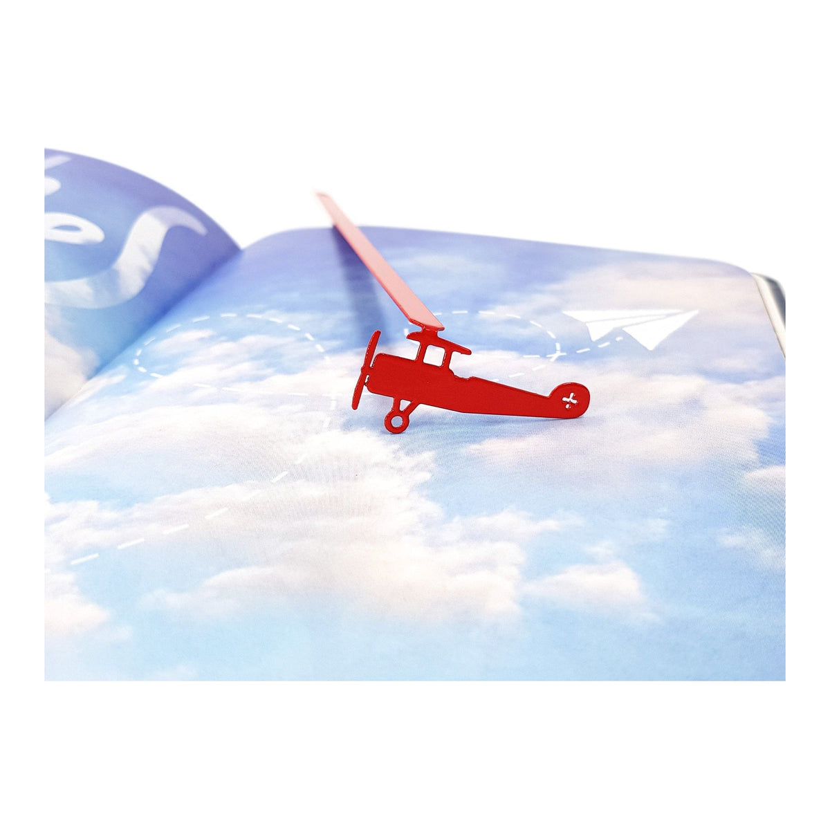 Red Biplane metal bookmark in red on a coloured background