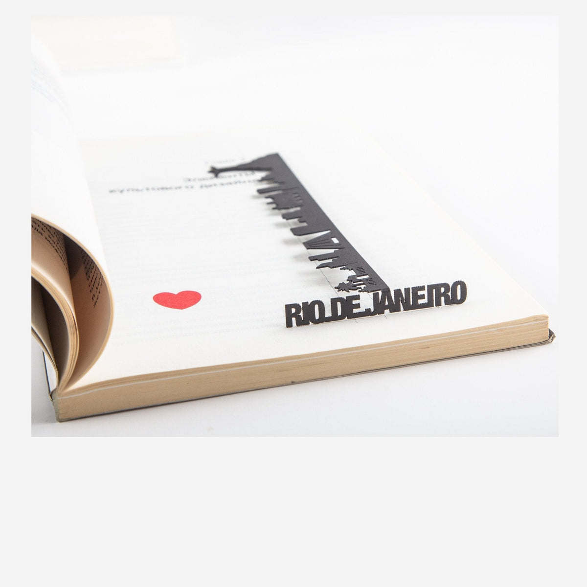 Rio De Janeiro metal bookmark marking a page in a notebook