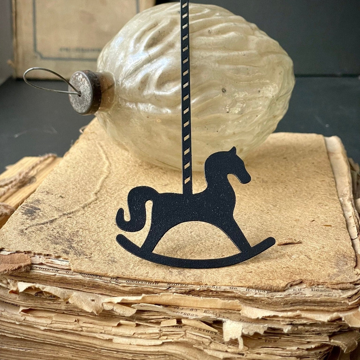 Rocking Horse metal bookmark on a coloured background