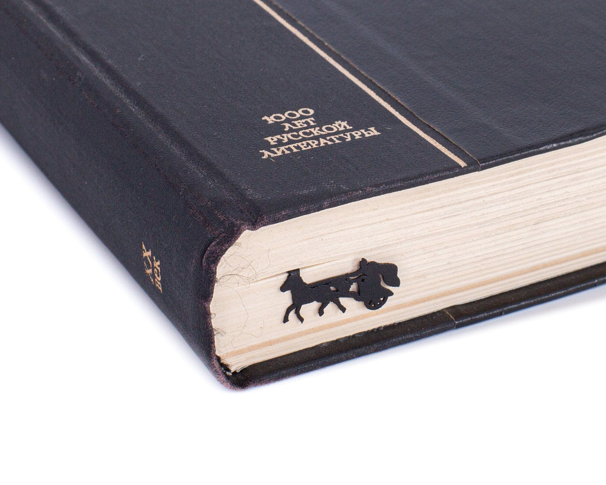 Roman Chariot metal bookmark seen from the edge of a closed book
