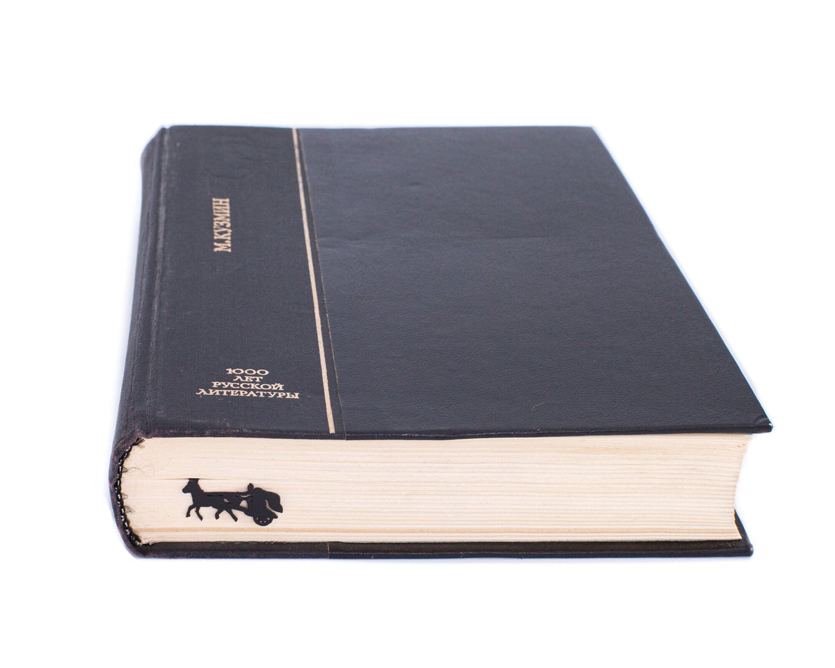 Roman Chariot metal bookmark in a closed book, only its top showing above the pages