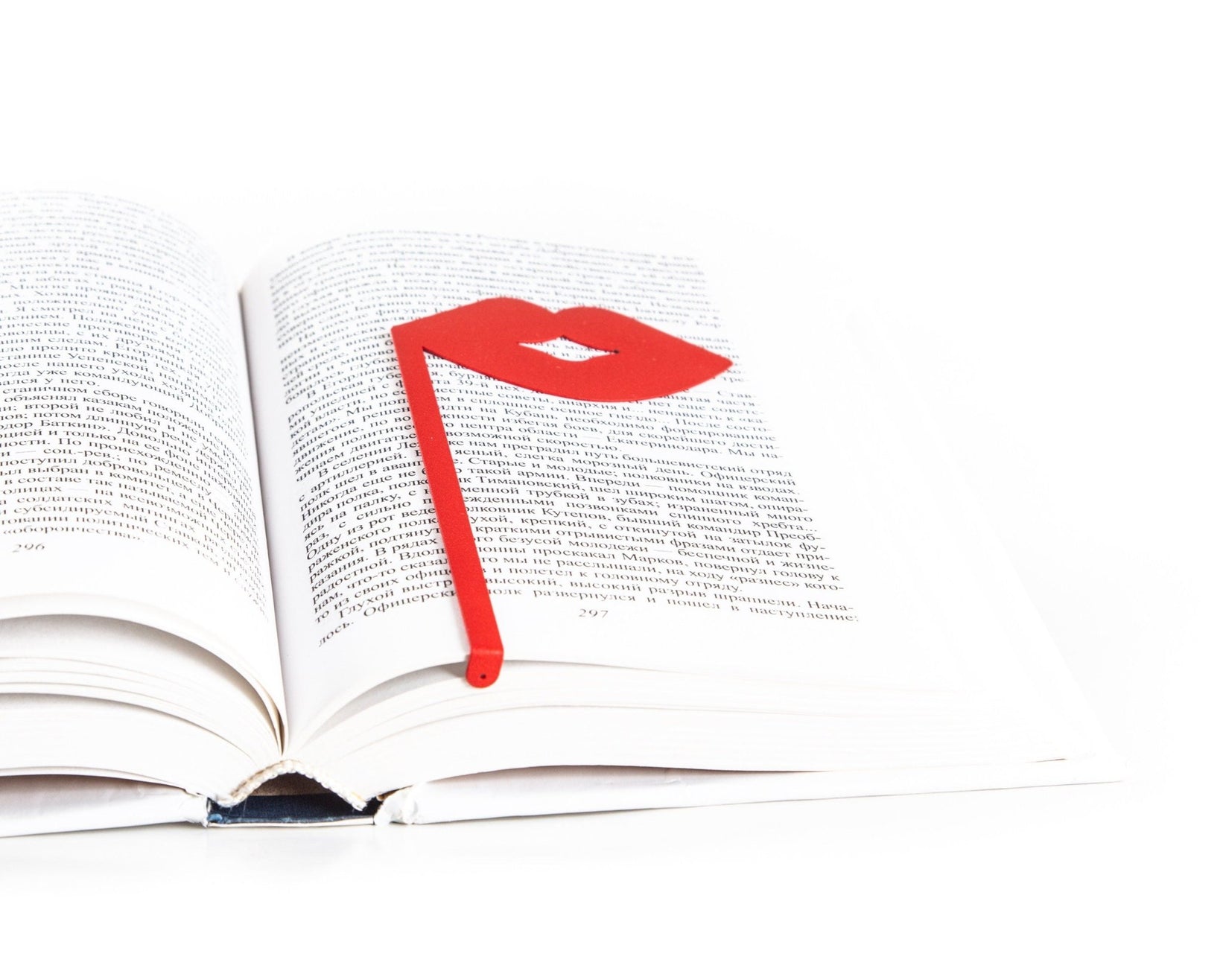 Romantic Red Lips metal bookmark in red resting on the pages of an open book