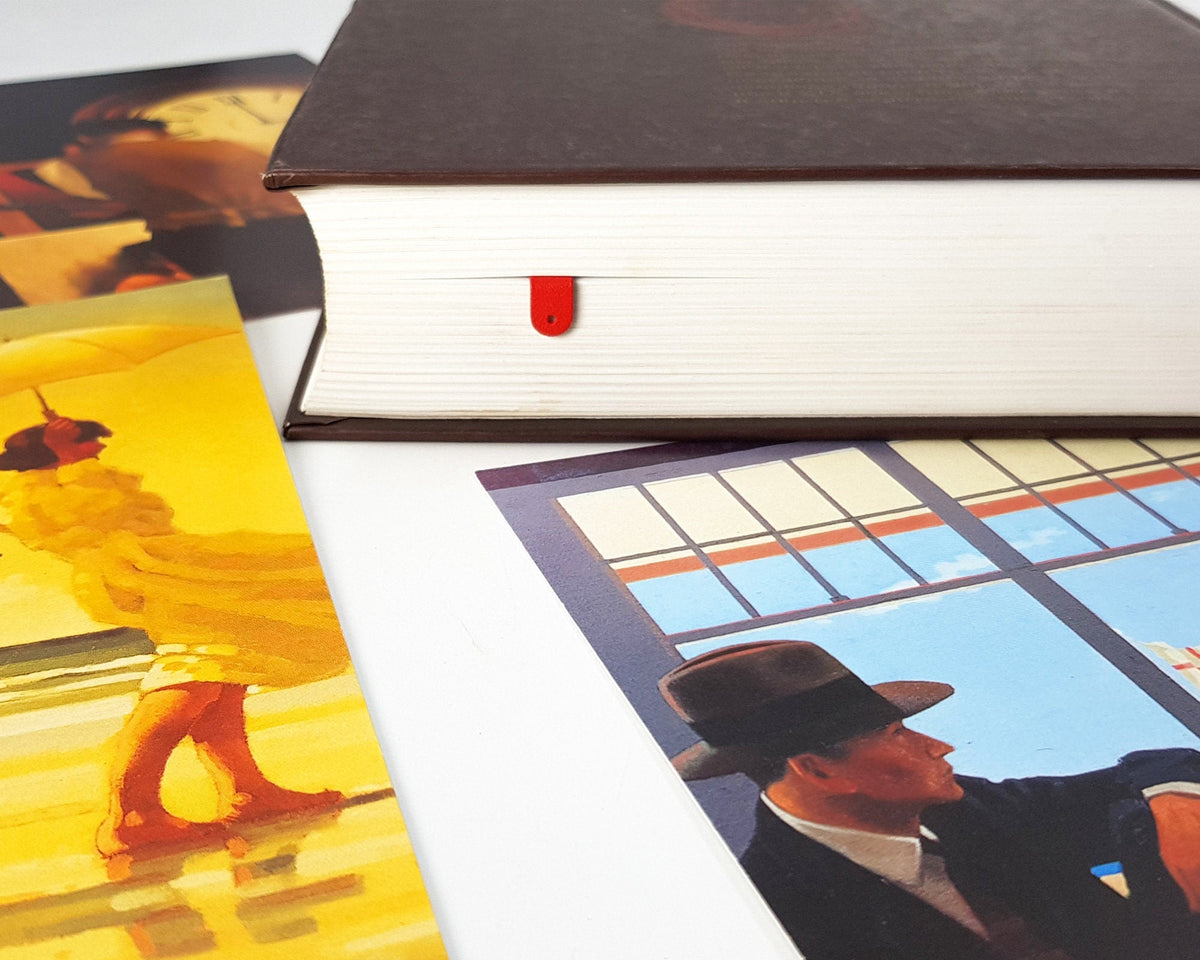 Romantic Red Lips metal bookmark in red marking a page in an illustrated book