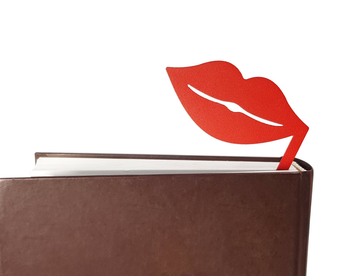 Romantic Red Lips metal bookmark in red in a closed book, only its top showing above the pages