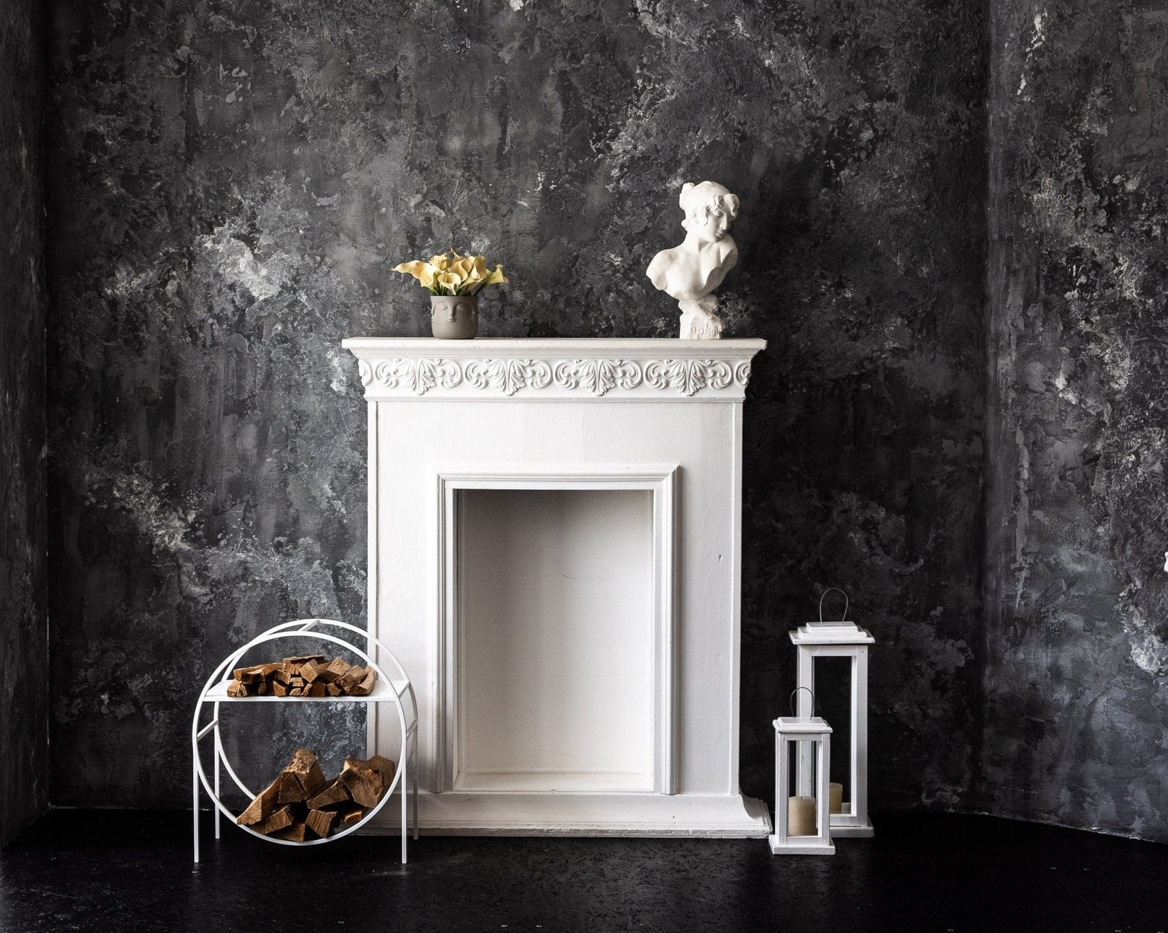 White round log holder with kindling shelf beside a fireplace