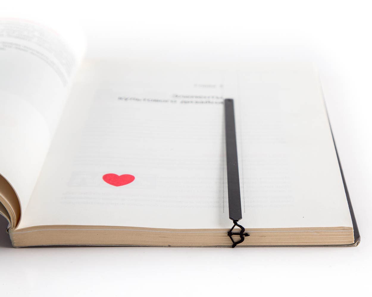 Sagittarius metal bookmark resting on the pages of an open book