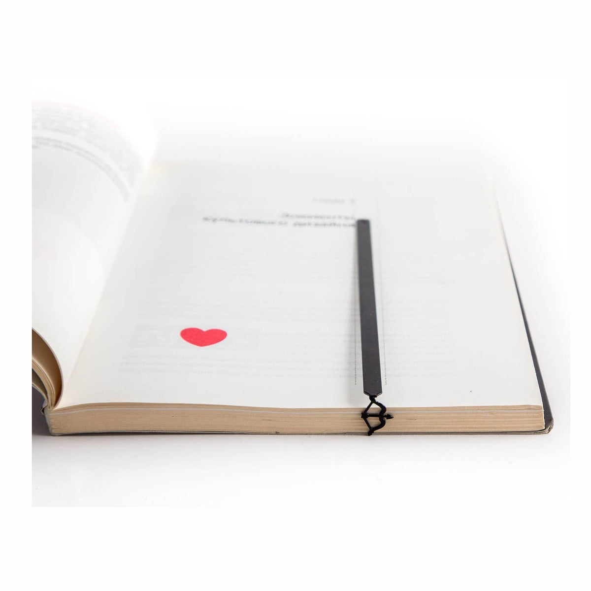 Sagittarius metal bookmark resting on the pages of an open book