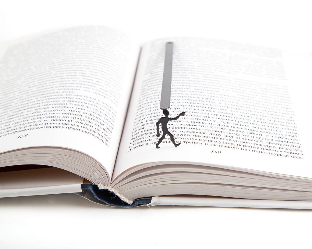 Zombies Are Coming metal bookmark resting on the pages of an open book