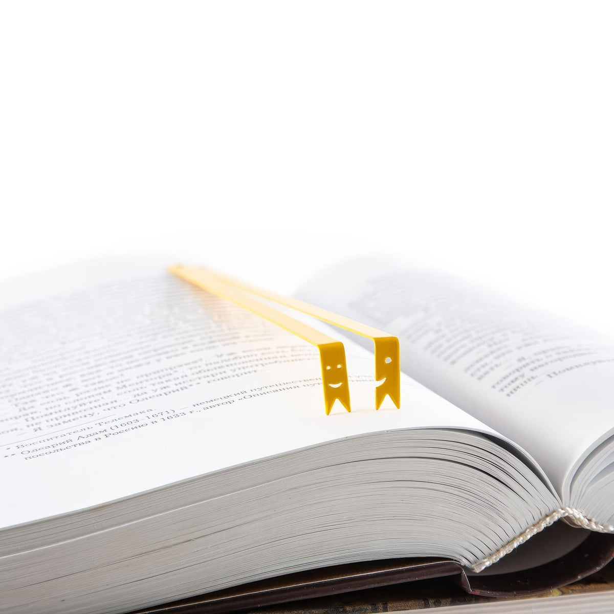 Smiling Ribbons Metal Bookmarks resting on the pages of an open book