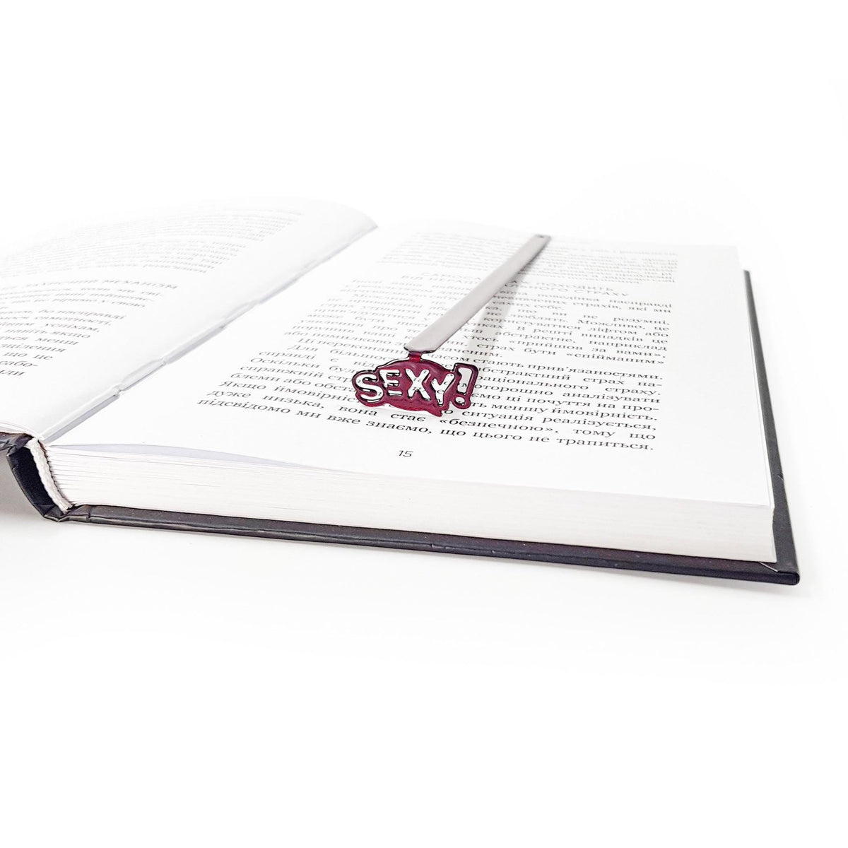 Sexy Smart metal bookmark seen from the edge of a closed book