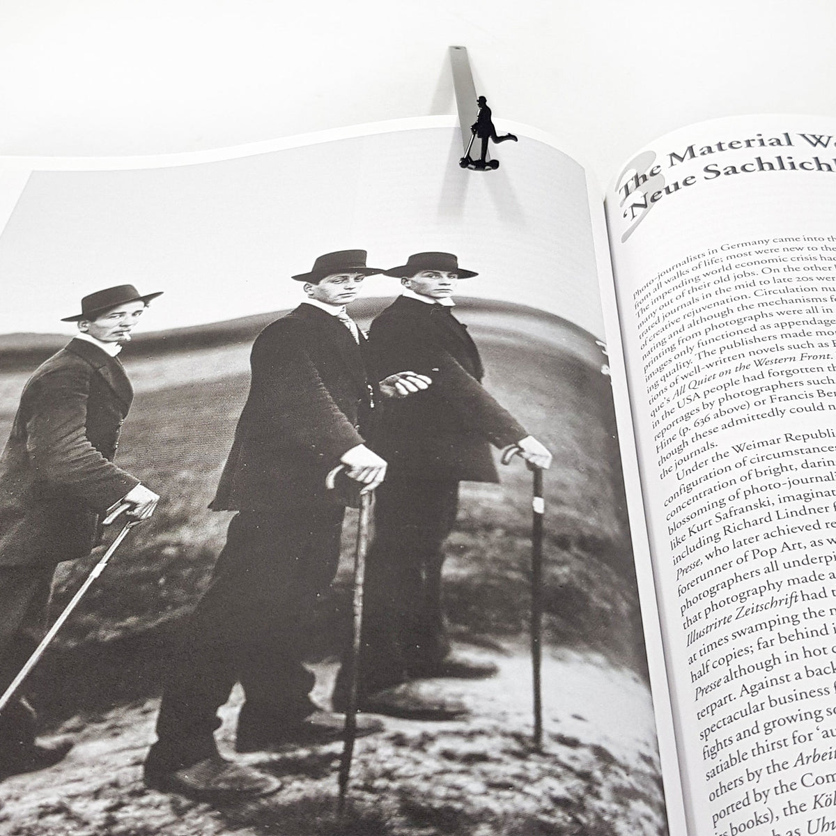 Skater Gentleman metal bookmark on an illustrated page