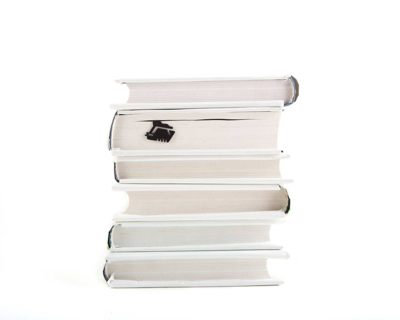 Happy Skeleton metal bookmark shown with a stack of books