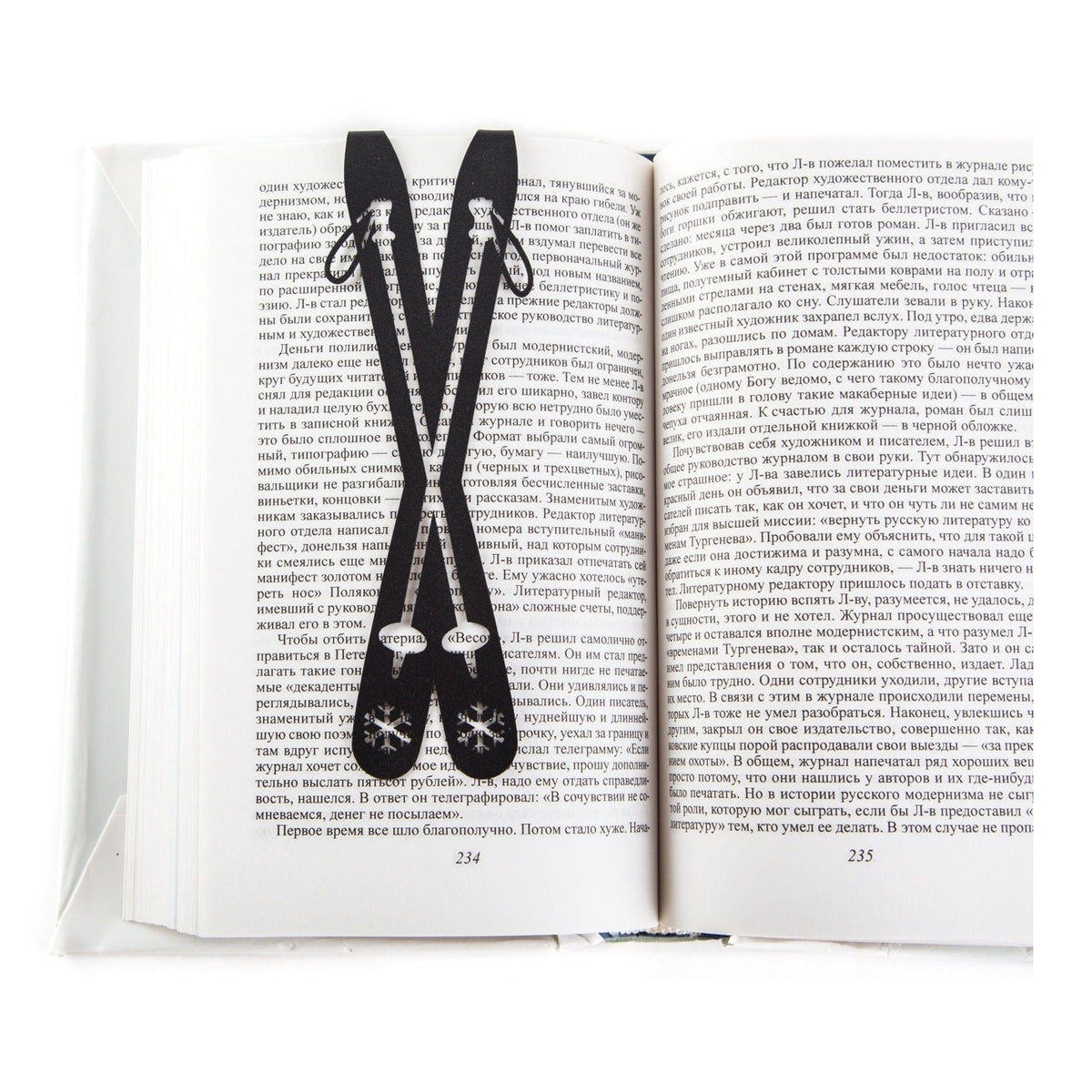 Skis metal bookmark resting on the pages of an open book