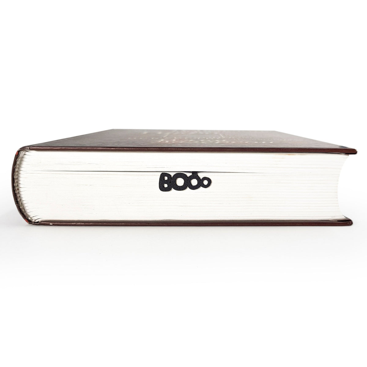 Sleep Tight metal bookmark in a closed book, only its top showing above the pages