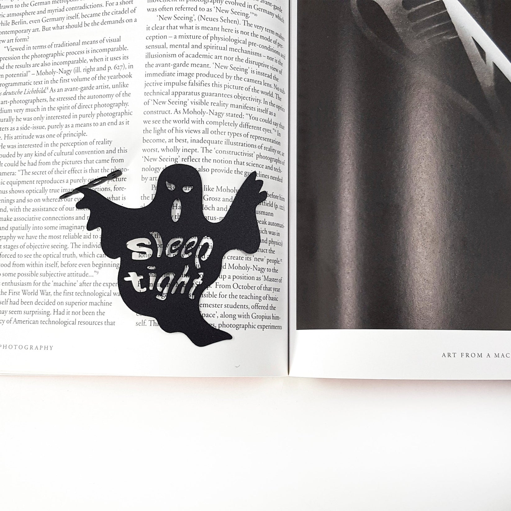 Sleep Tight metal bookmark marking a page in an illustrated book