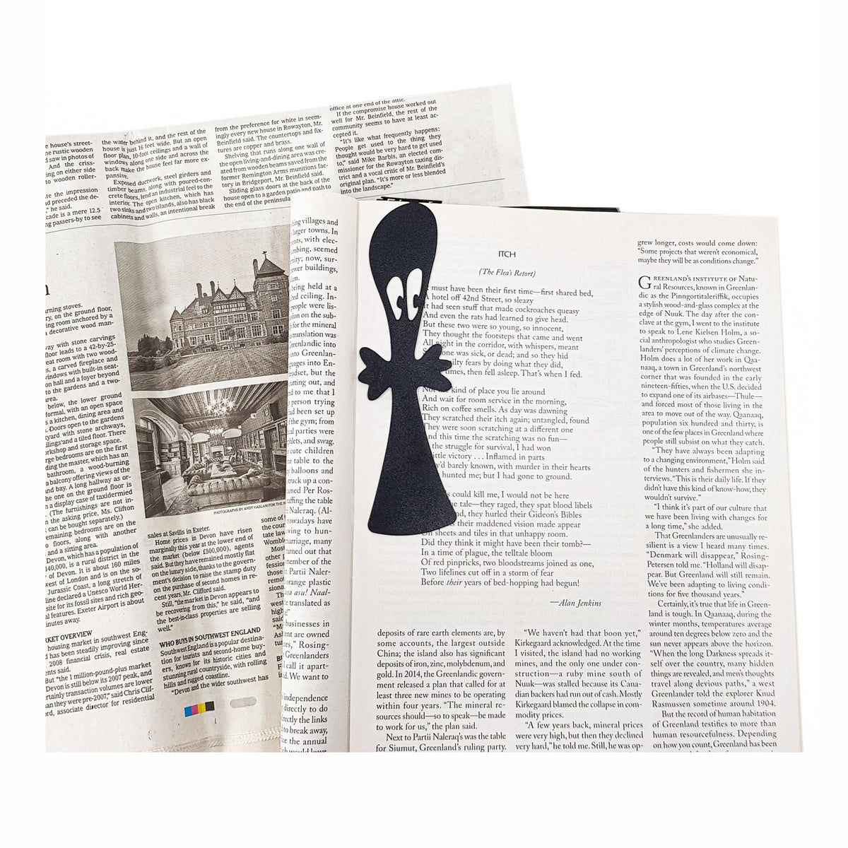 Small Ghost metal bookmark resting on the pages of an open book