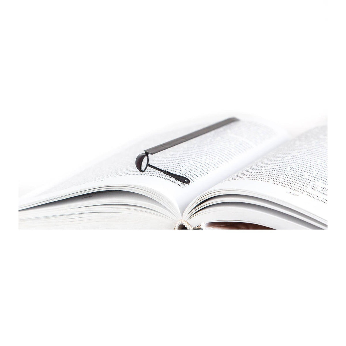 Soup Ladle metal bookmark resting on the pages of an open book