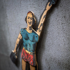 close up of articulated plywood strongman puppet lifting weight, vintage style design