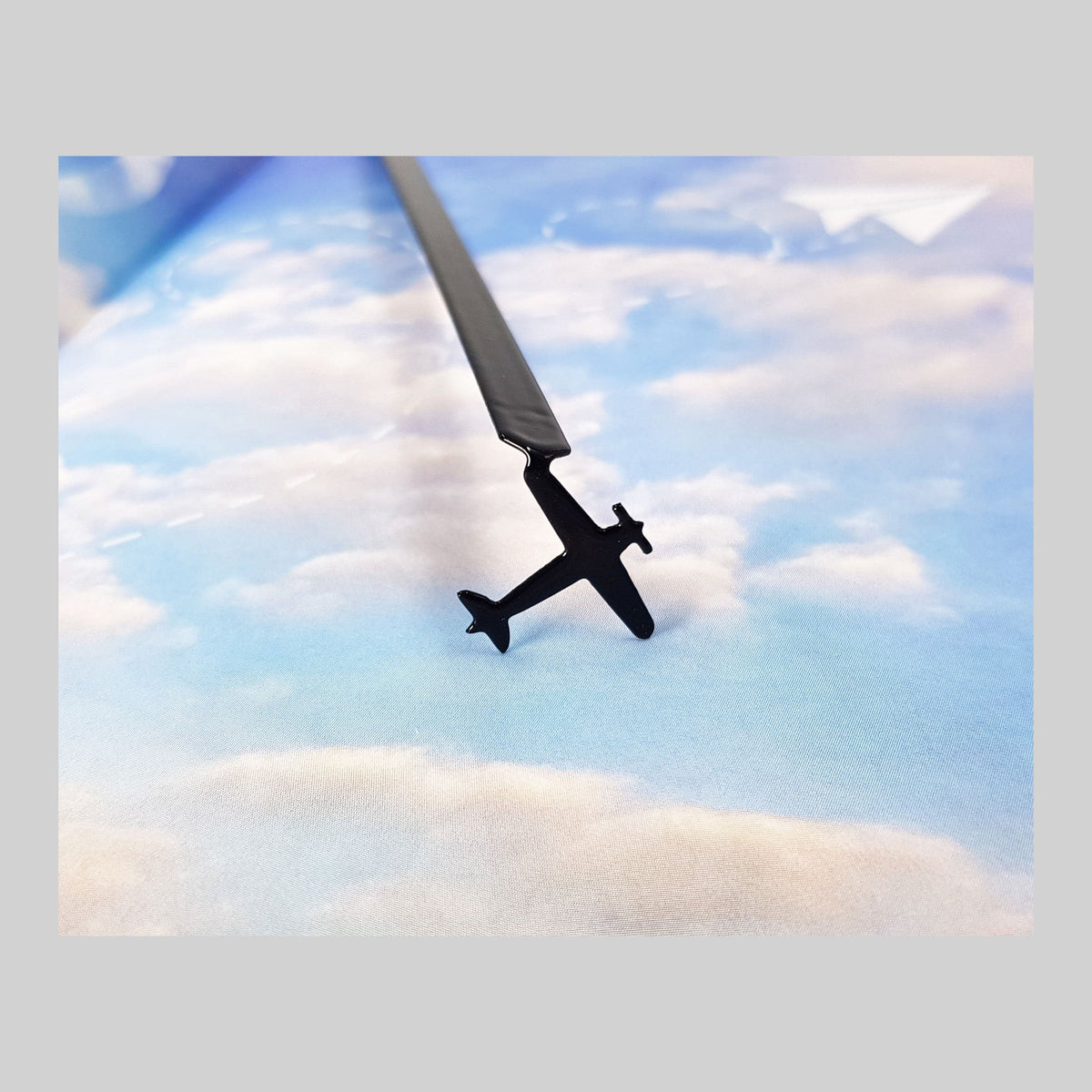 Take a Book Will Fly metal bookmark on a coloured background