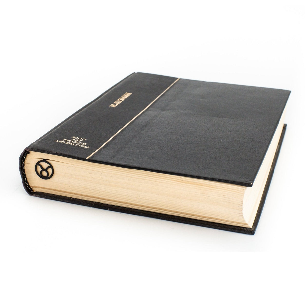 Taurus metal bookmark in a closed book, only its top showing above the pages