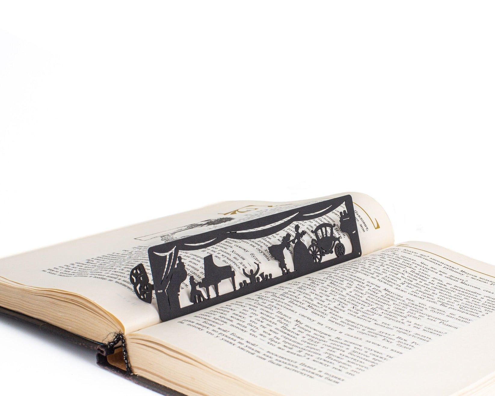 Theater metal bookmark resting on the pages of an open book