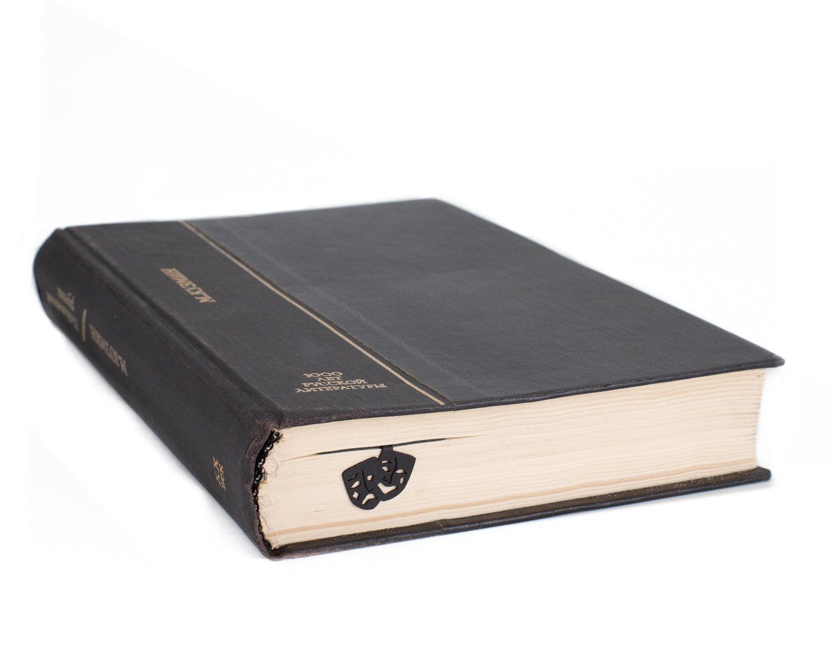 Theater metal bookmark seen from the edge of a closed book