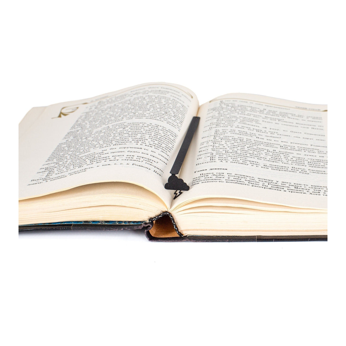 Thunderstorm metal bookmark resting on the pages of an open book